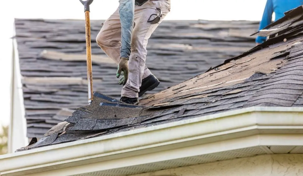 Close-up roof repair work replacing shingles and sealing roof surface in Naperville IL
