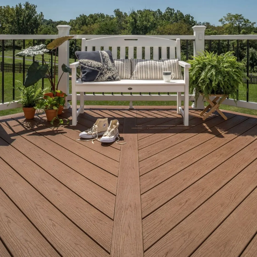 Light gray composite deck with black wicker patio furniture near pool, built by composite decking builders in Lombard, IL