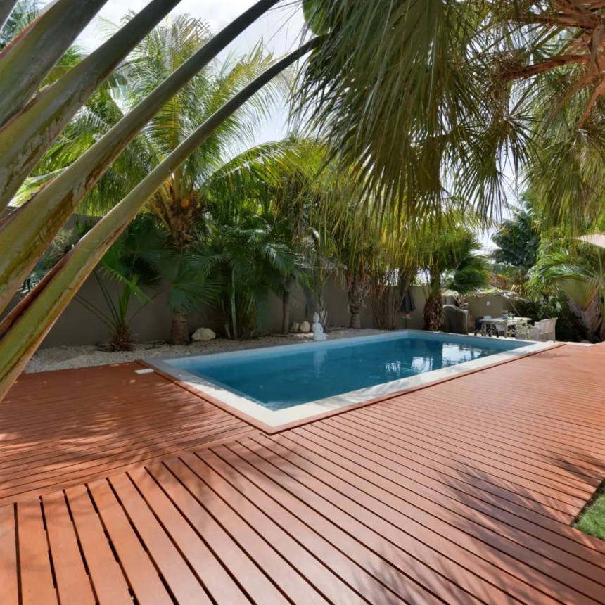 Brown diagonal composite decking with white bench and lush green view, created by Trex deck builders in Lombard, IL