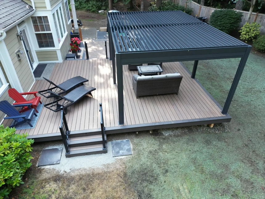 Classic composite deck with wood-grain texture and wooden chairs, perfect for low-maintenance outdoor living.