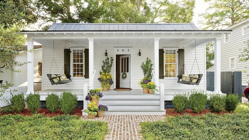 Front deck ideas for ranch style homes with symmetrical swings, white columns, and lush landscaping.