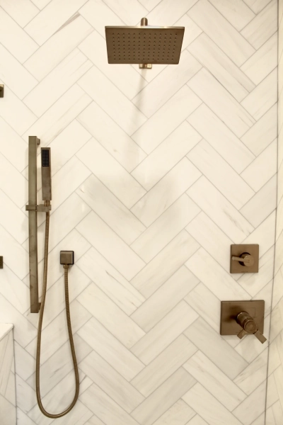 Close-up of champagne bronze hardware and shower fixtures