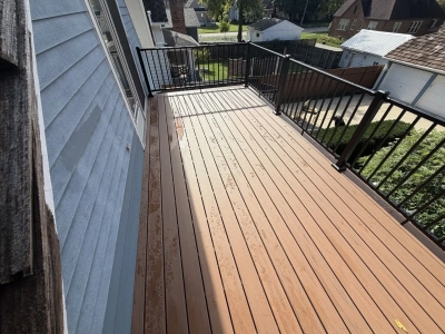 Wide view of Trex Lineage decking in Hatteras with a picture-frame border and black railing in Plainfield, IL.