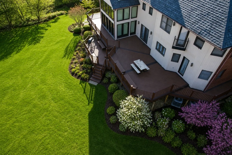 Aerial view of multi-level composite deck with dining area and landscaping built by deck builder in Lombard IL