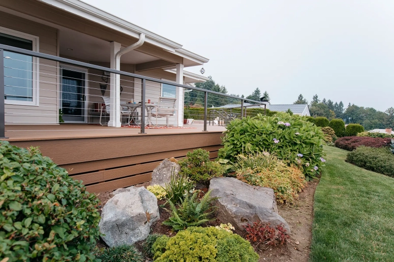 Composite deck with cable railing and landscaping built by deck builder in Oak Brook IL