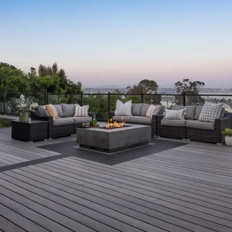 Dark composite deck with fire pit and outdoor seating area built by deck builder in Oak Brook IL