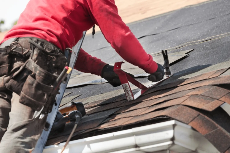 Roofer repairing flashing and shingles on a home in Downers Grove IL