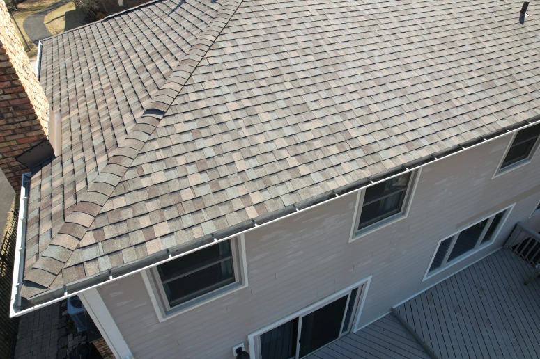 Aerial view of asphalt shingle roof with hip and valley detail on two-story home repaired in Wheaton IL