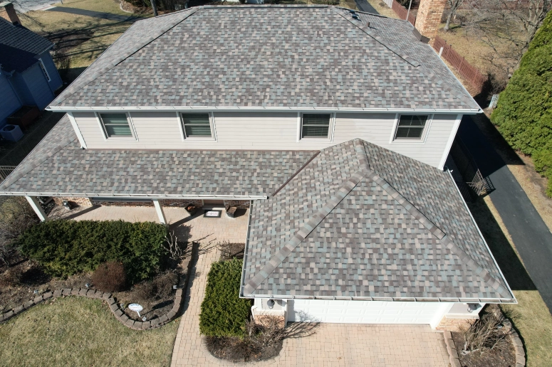 Completed asphalt shingle roof replacement on a residential home in Geneva IL by Naperville Roofing and Construction.