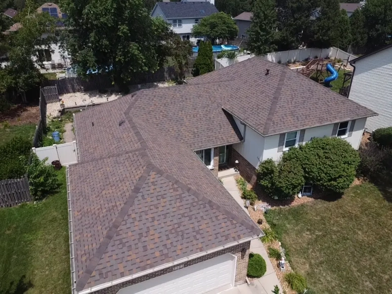 Drone view of new asphalt shingle roof installed on residential home in Geneva IL by Naperville Roofing and Construction