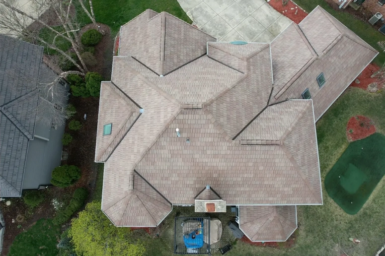 Aerial view of completed asphalt shingle roof replacement on large multi-gable home in Geneva IL