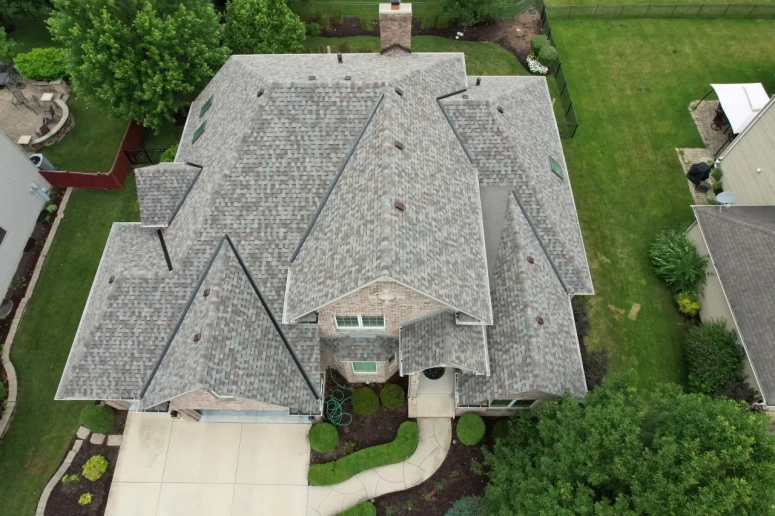 Aerial view of architectural shingle roof replacement on a large residential home in Lombard IL by Naperville Roofing and Constr