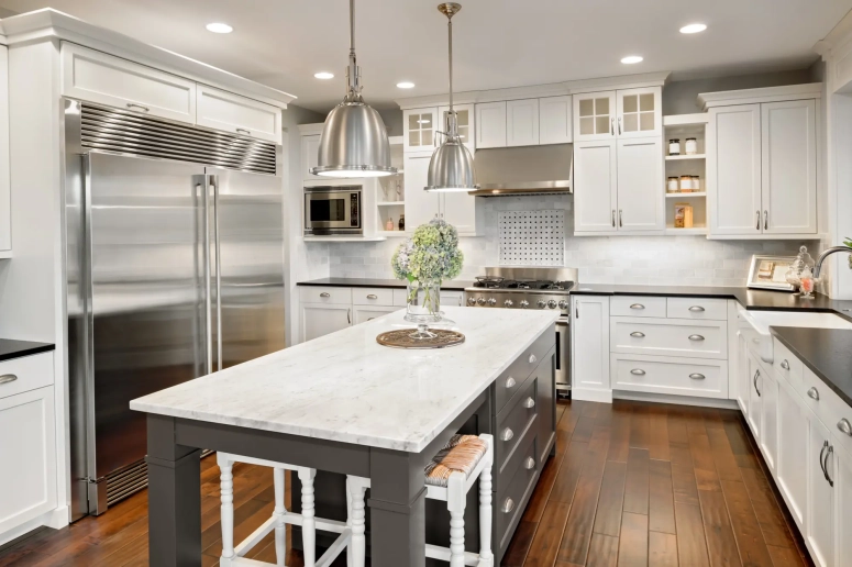 White shaker perimeter cabinets with dark gray island after kitchen cabinet resurfacing