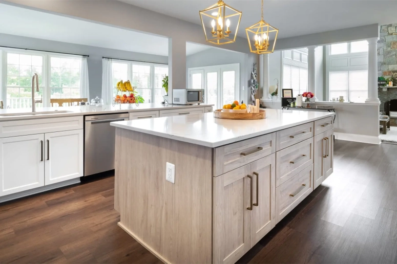 Two-tone white and natural wood kitchen cabinets with quartz countertops and gold hardware after resurfacing